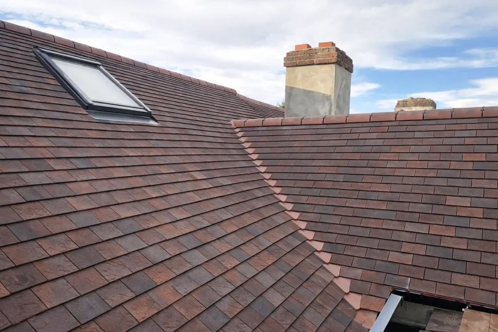 loft conversion brown tiled roof and velux window london | AJ Contractors Builder | Home Extensions & Renovation in East London