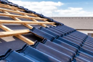 Close-up of concrete roof tiles being installed on a pitched roof in Chingford, E4