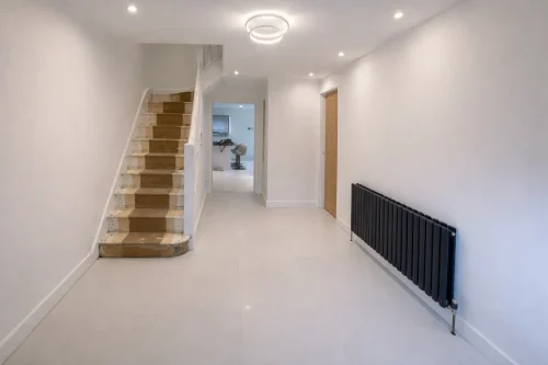 Renovated hallway interior with wooden flooring and recessed lighting in Barking, IG11